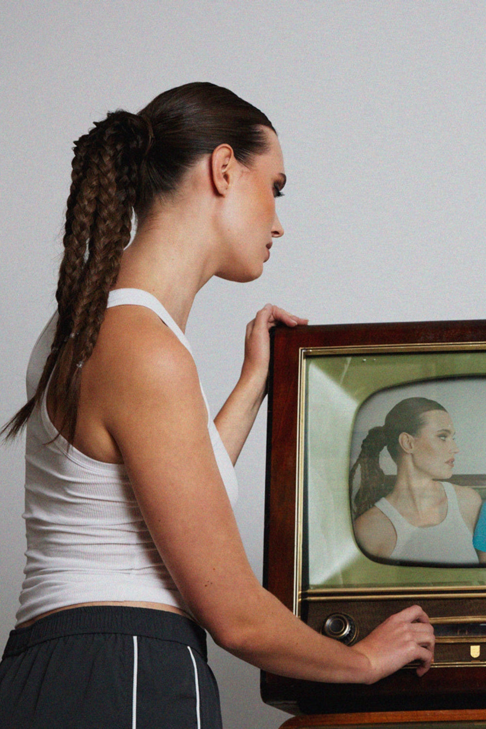 A model wearing BHBD hairband in a ponytail with braids